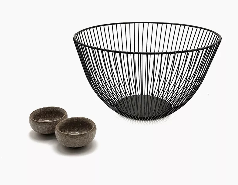 A black wire basket and two small bowls.
