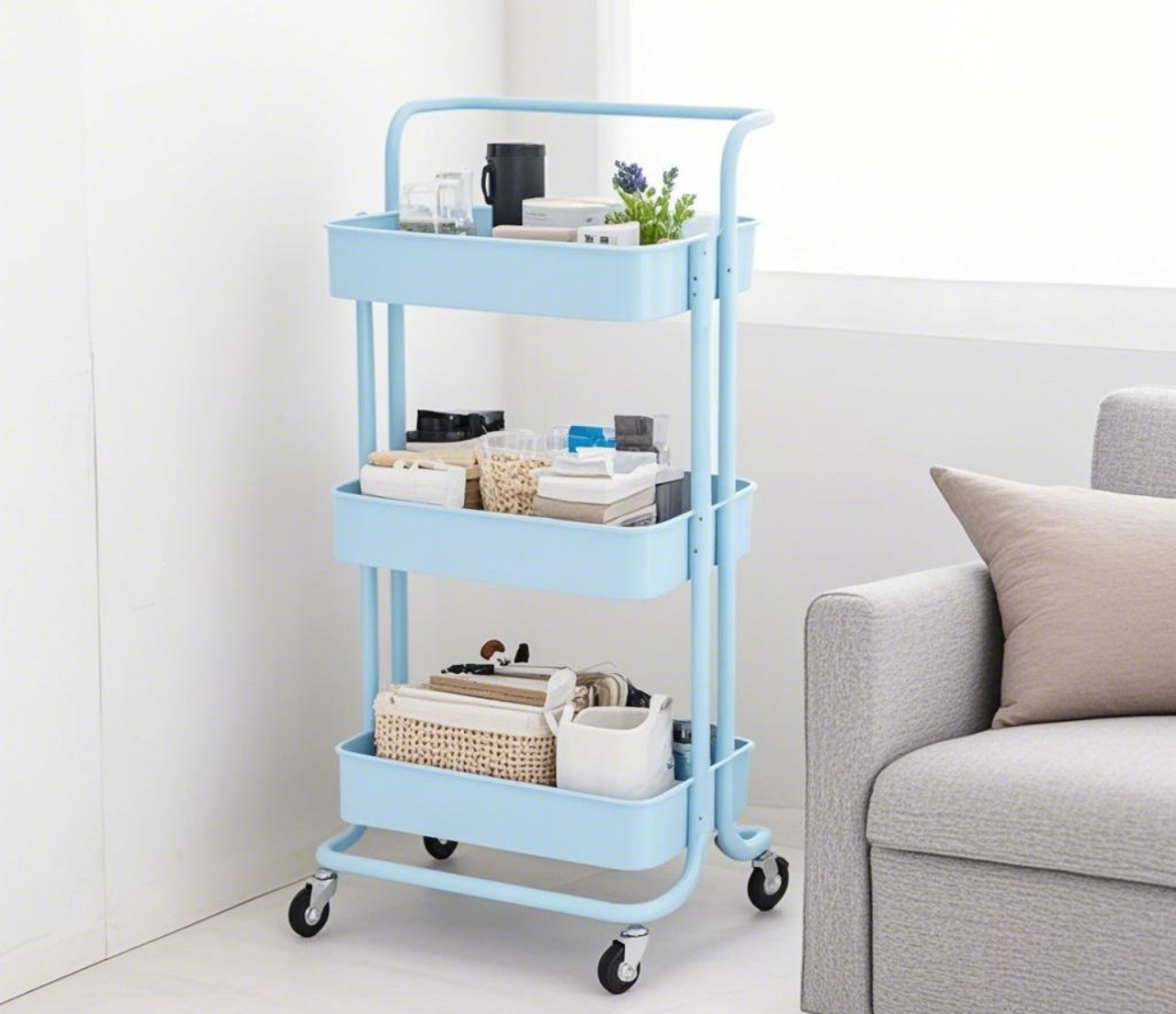 Light - blue three - tier cart with items.