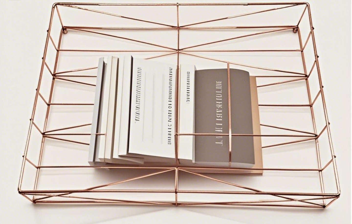 Copper wire rack with books.